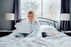 Woman under covers in a bed