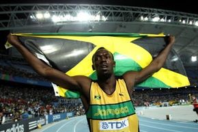 Sprinter Usain Bolt waves the Jamaican flag after winning the gold medal in the 200 meters at the IAAF World Championships in September 2011.  Bolt, who holds the world records in the 100 and 200 meters, is considered &quot;the fastest man alive.&quot;
