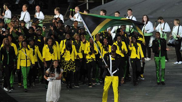 Men in uniforms parade outdoors, celebrating cultures.