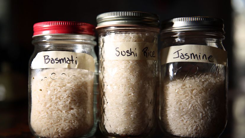 Three jars of rice on display: basmati, sushi and jasmine