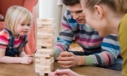 Family playing Jenga together. 