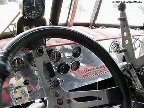 Hand-fabricated dashboard in a stock 1985 Peterbilt cab. Above the steering wheel is a zero to 300-mph airspeed indicator.