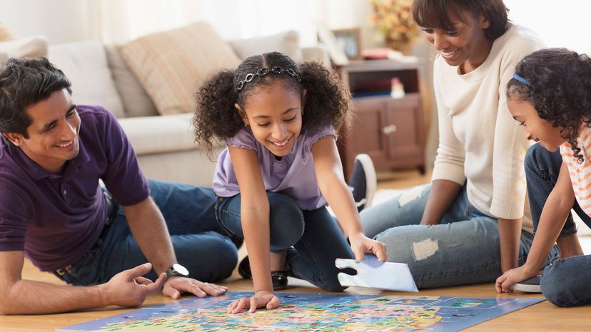 family doing puzzle