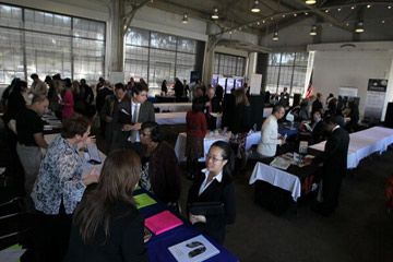 Job seekers speak to recruiters at a San Francisco, Calif., job fair. 