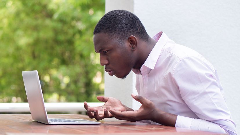 young man glaring at computer