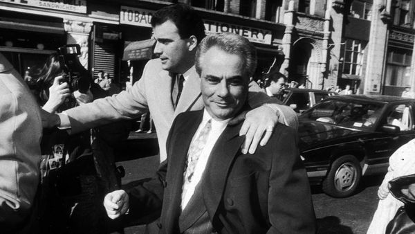 Men in suits outdoors in black and white.