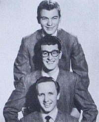 Bespectacled Buddy Holly, with the Crickets, Jerry Allison (top) and Joe B. Mauldin (bottom). Holly’s music influenced John tremendously.