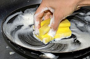 washing dishes with a sponge