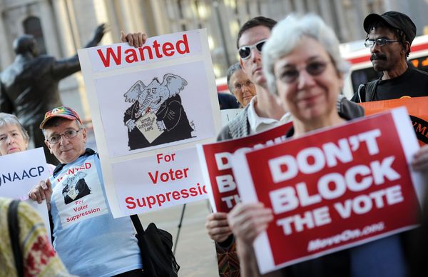 Activists hold protest signs in solidarity.