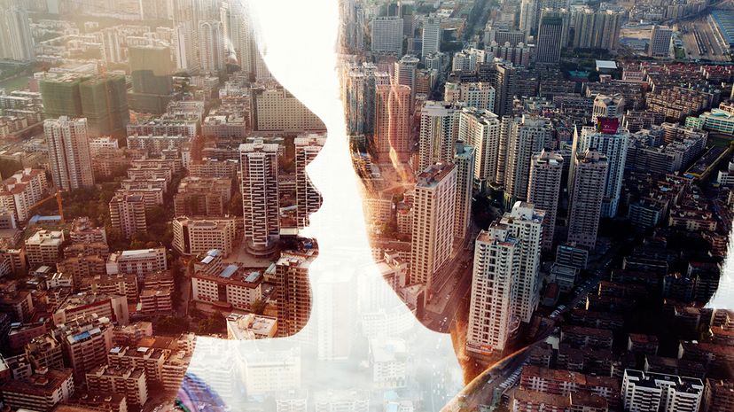 image of two people sharing secret over double exposure cityscape