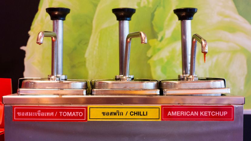 A product labelled 'American ketchup' sits next to two local condiments in a fast food restaurant in Thailand. Peter Ptschelinzew/Lonely Planet/Getty Images