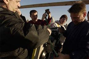 Key grip Dean Citroni (right) prepares a scene during the filming of 'Thank You for Smoking.' The key grip is the supervisor of all the grips, who set up and move the cameras on set.