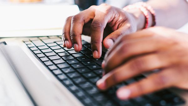 hands on a laptop keyboard