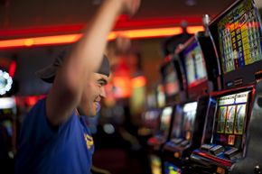 Young person celebrating at slot machine