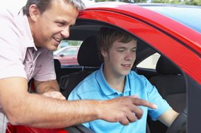 father teaching son to drive