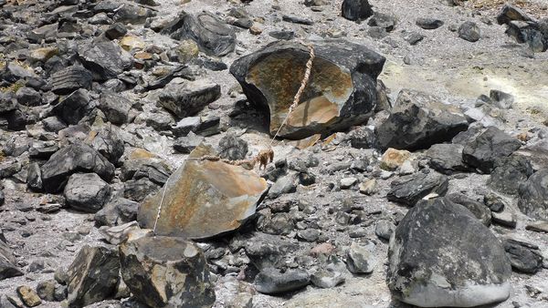 Stone object in nature surrounded by rocks.