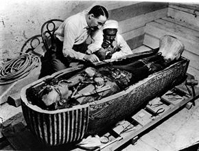 Archaeologist Howard Carter and an assistant examine the coffin of Tutankhamen with little regard for the &quot;curse.&quot;