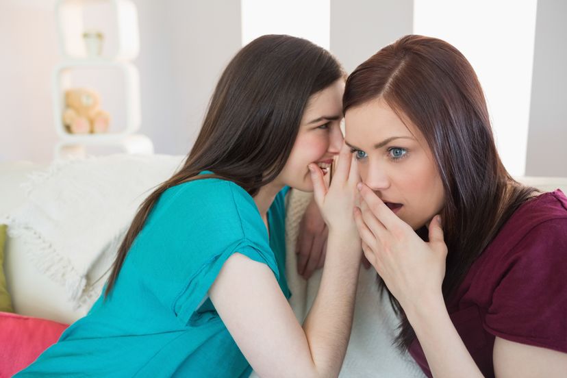 A woman telling something to her friend