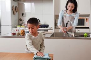 cleaning kitchen, mom and son cleaning kitchen, boy wiping down table