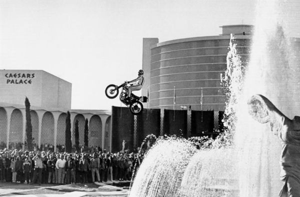 Men performing stunts outdoors in black and white.
