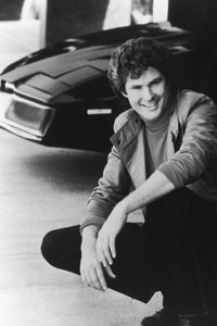 Actor and singer David Hasselhoff poses next to the computerized car, KITT, c. 1985.