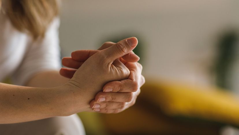 Close up shot of unrecognizable White woman struggling cracking her knuckles.