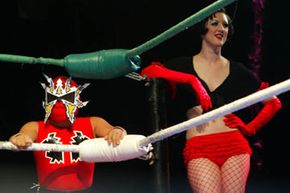 Tsuki, a lucha libre &quot;mini,&quot; performs alongside a burlesque dancer at a Lucha VaVOOM show at the Mayan Theatre in Los Angeles.