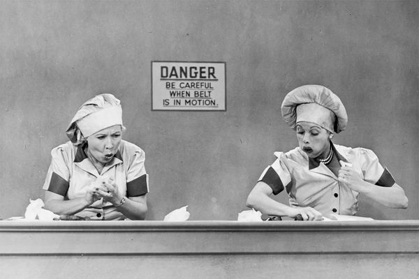 Actresses Vivian Vance and Lucille Ball stuff chocolate in their mouths in an episode of "I Love Lucy."