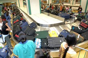 Tourist's journey begins with luggage at airport terminal.