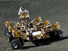 Space suit engineer Dustin Gohmert drives NASA's new lunar truck prototype through Johnson Space Center's Lunar Yard. The truck was built to make stuff like offroading easy.