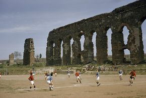 Italy Image Gallery A soccer game unfolds at the foot of an ancient aqueduct in Rome. Los Angeles used the water system of ancient Rome as a model for its own infrastructure. See more pictures of Italy.