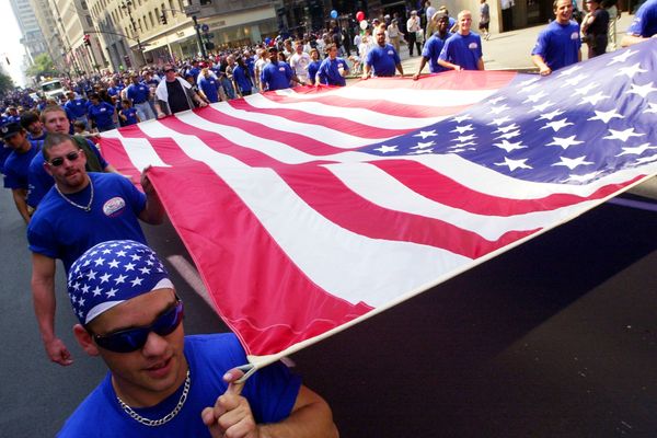 Patriotic men celebrating sport with American flag.