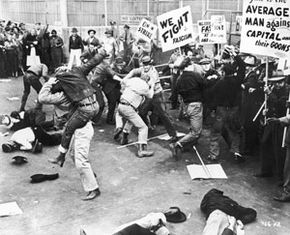 Strikers fight with a group of scabs as they try to cross a factory picket line in this photo from 1935. See more corporation pictures.