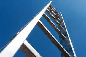 A metal ladder against a blue sky.