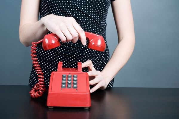 Girl hanging up landline