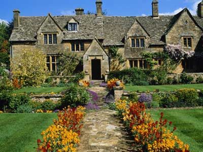 Traditional Cotswold house and gardens, Gloucestershire, England.
