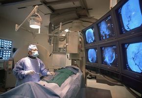 doctors looking at brain images while conducting surgery