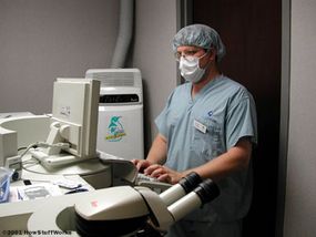 Bryan Lemon, Laser Engineer, makes adjustments to the Excimer laser before the surgery.