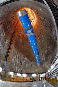 CERN engineers lower a large dipole magnet into the LHC tunnel.