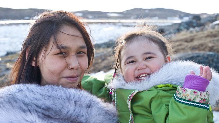 Inuit mother and her daughter wear traditional amouti, Baffin Island