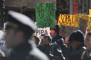 Protesters show their disdain for the Stop Online Piracy Act (SOPA) and the Protect IP Act (PIPA) on January 18, 2012 in New York City.