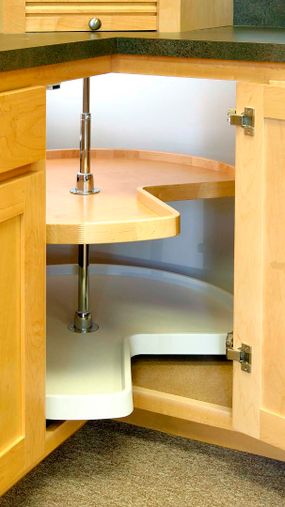 A rotating shelf (known as a Lazy Susan) in the corner cabinet of a kitchen.