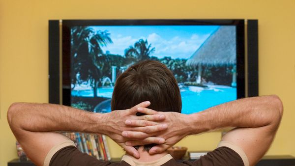 man watching LED TV