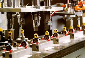 Machines assemble components that require several pieces, like minifigures