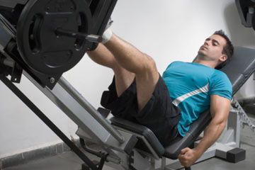 Person exercising on exercise machine for a healthy, muscular lifestyle.