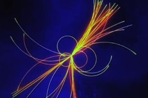 A graphic projected onto a screen shows traces of collision of particles, during the Large Hadron Collider Conference at Museo della Scienza e della Tecnica (Milan Museum of Science and Technology) on Dec. 20, 2011 in Milan, Italy.