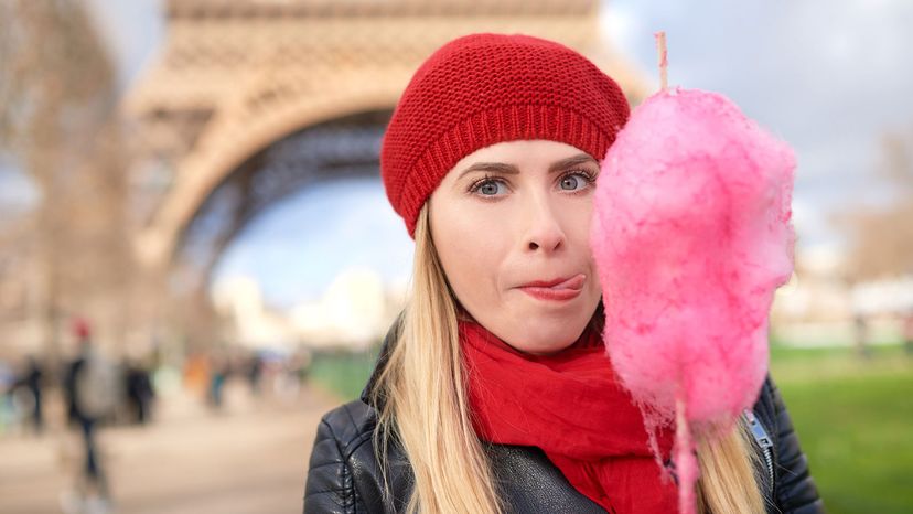 woman licking cotton candy