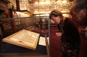 A visitor gazes upon an original copy of the Magna Carta at New York's Morgan Library and Museum, in April 2010.