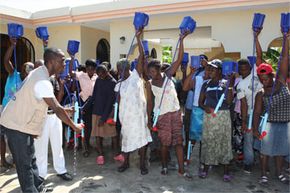 October 2010: Residents at the Croix Des Bouquets camp north of Port Au Prince, Haiti receiving training to use LifeStraw Family. See more green science pictures.