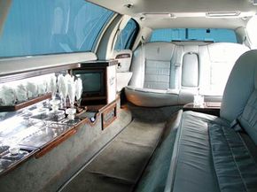 The interior of a stretch limo, complete with bar and entertainment center.